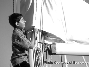 boy sailing a sailboat
