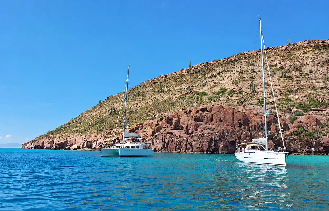 Catamaran and sailboat anchored in a cove near La Paz, Mexico